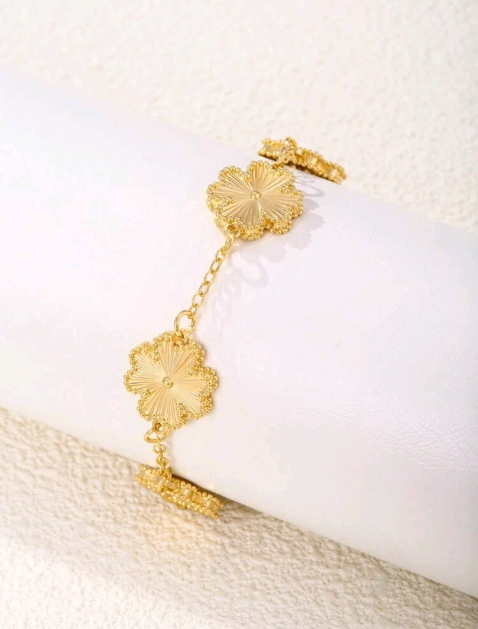 Elegant gold chain bracelet with five textured clover flower motifs and adjustable length - luxury designer inspired jewellery for UK customers