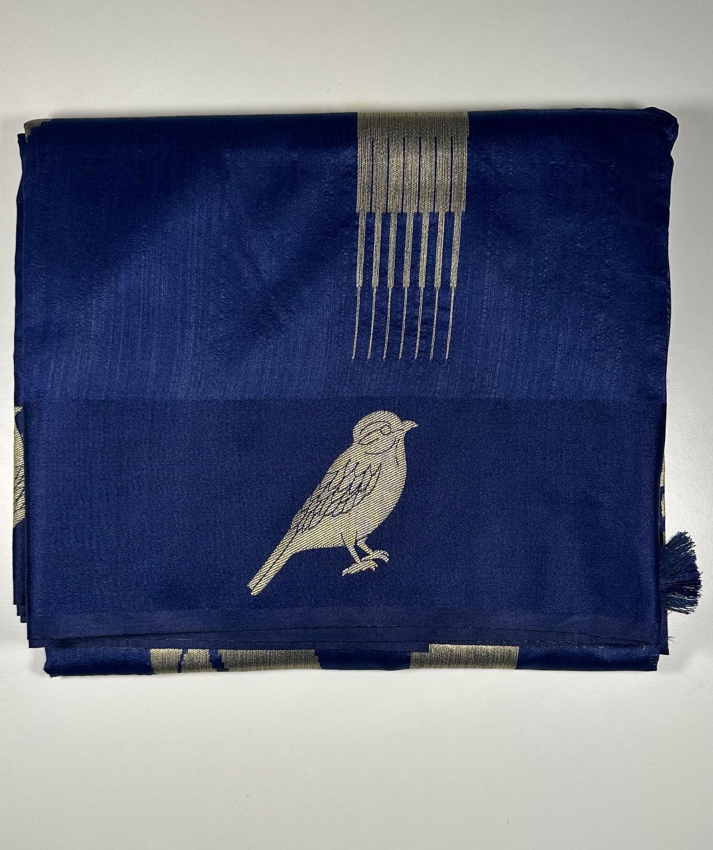 Royal blue silk saree with woven bird and floral motifs showing nature-inspired traditional Indian design and lustrous silk fabric quality