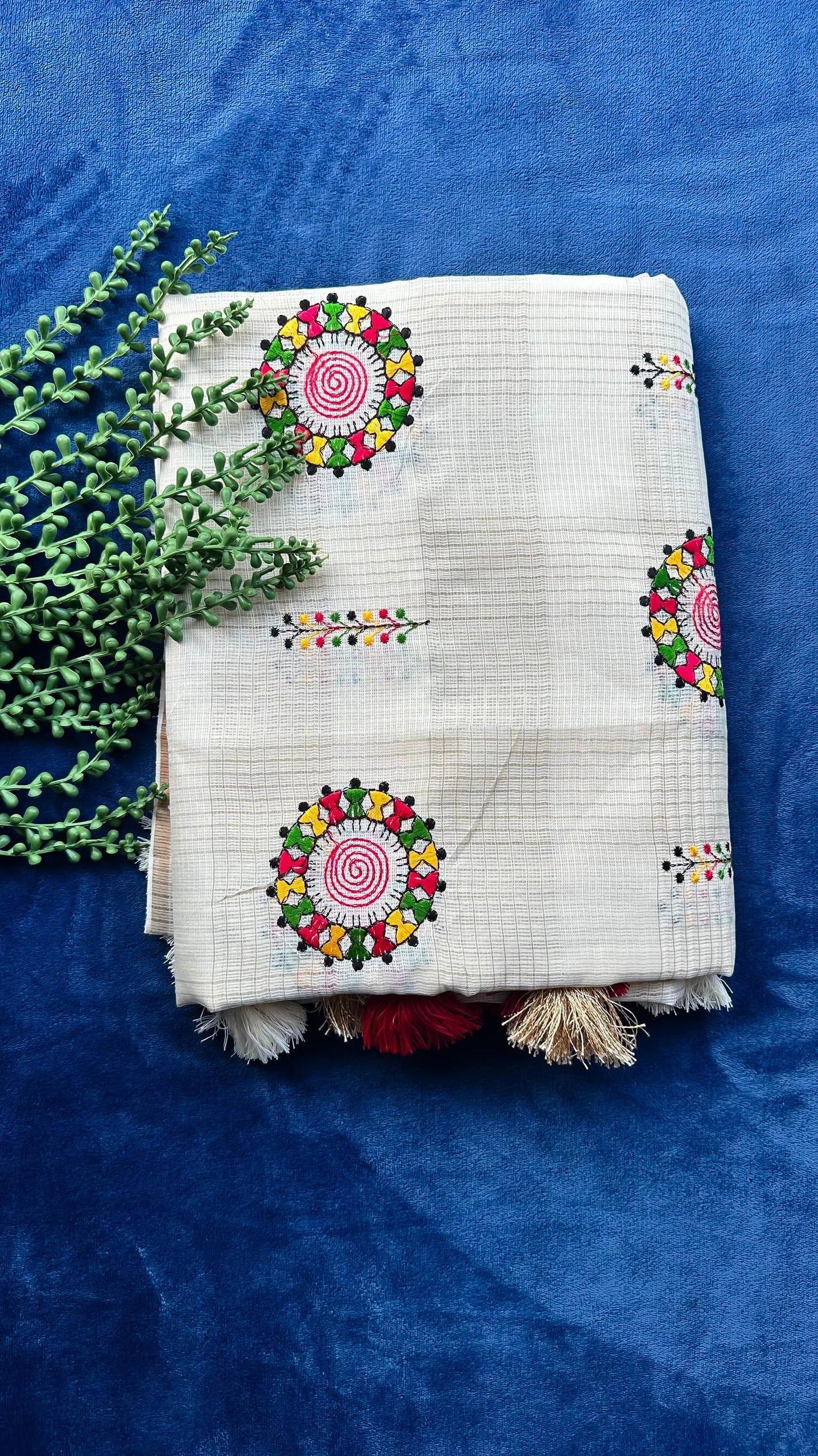 Hand-embroidered cotton saree with colorful folk art motifs showing traditional Indian handloom fabric and artisan embroidery work