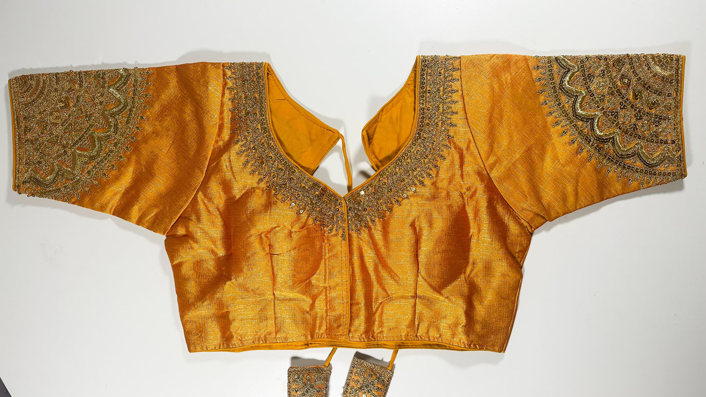 Golden embroidered saree blouse with heavy zardozi work showing traditional Indian bridal choli design with intricate handwork