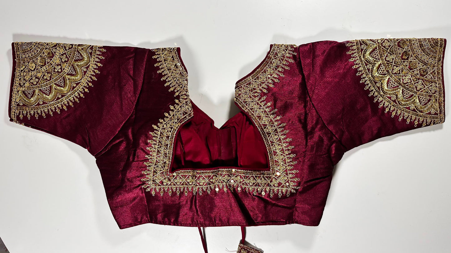 Traditional Indian luxury choli in rich wine burgundy silk with elaborate gold embroidery perfect for elegant occasions