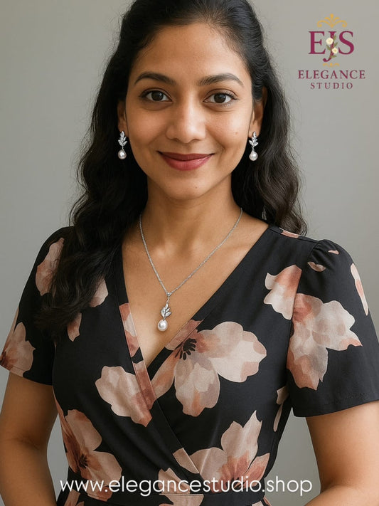 Beautiful woman wearing silver crystal leaf pearl jewelry set with floral dress showing elegant everyday styling