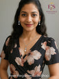 Beautiful woman wearing silver crystal leaf pearl jewelry set with floral dress showing elegant everyday styling