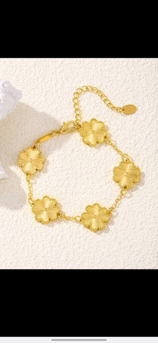 Elegant gold chain bracelet with five textured clover flower motifs and adjustable length - luxury designer inspired jewellery for UK customers