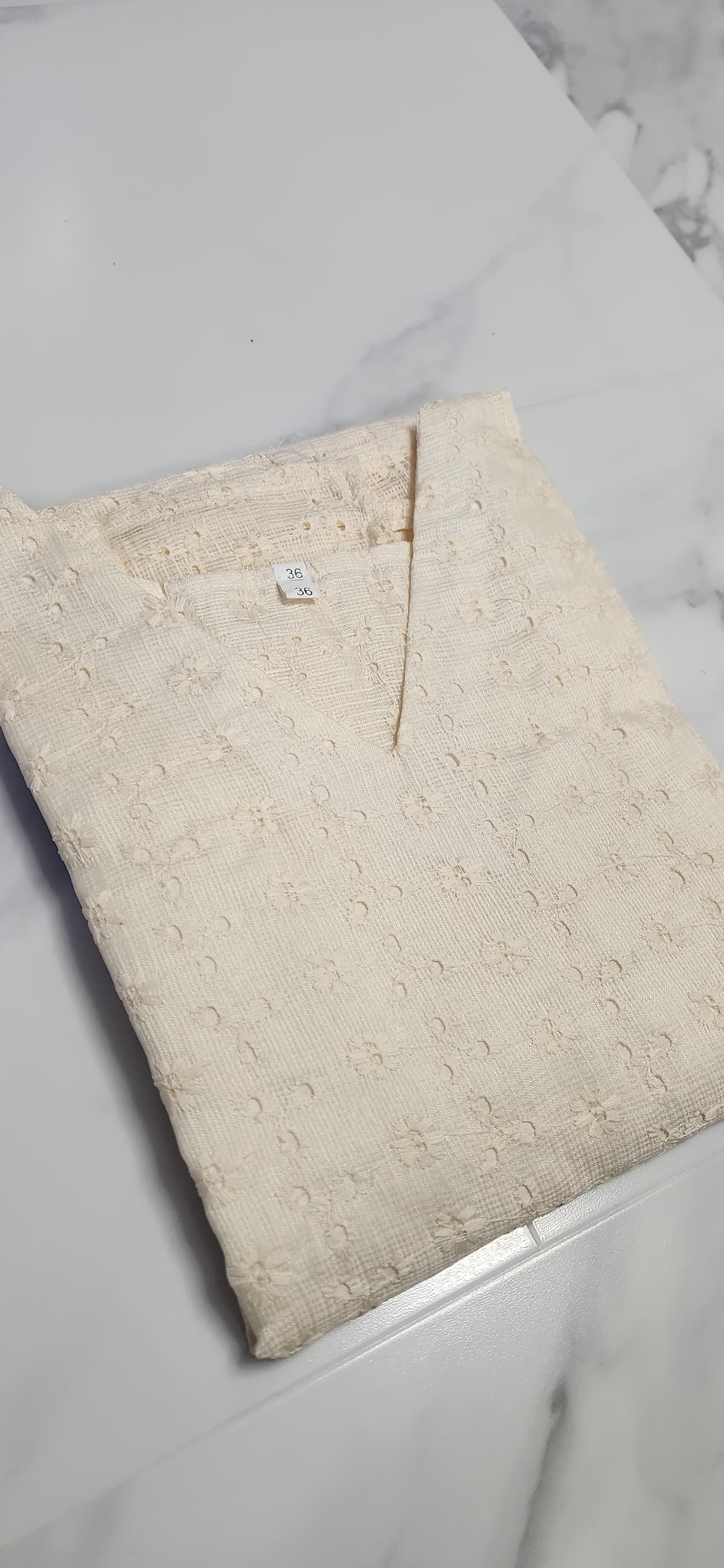 Off-white Hacoba cotton sleeveless kurta with self-textured embroidery, includes attached matching sleeves inside — elegant and versatile ethnic wear for women.