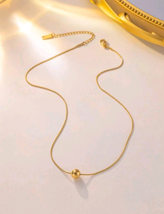 Minimalist gold ball pendant necklace on delicate snake chain in luxury gift box - contemporary designer jewellery for UK customers