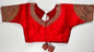 Red embroidered saree blouse with heavy zardozi work showing traditional Indian bridal choli design with intricate gold handwork