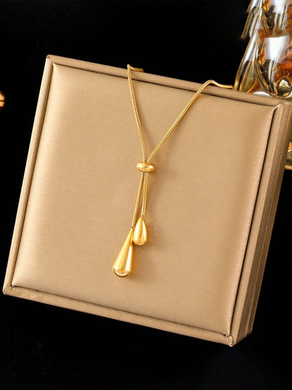 Elegant gold adjustable lariat necklace with teardrop pendants and sliding mechanism in luxury gift box - contemporary designer jewellery UK