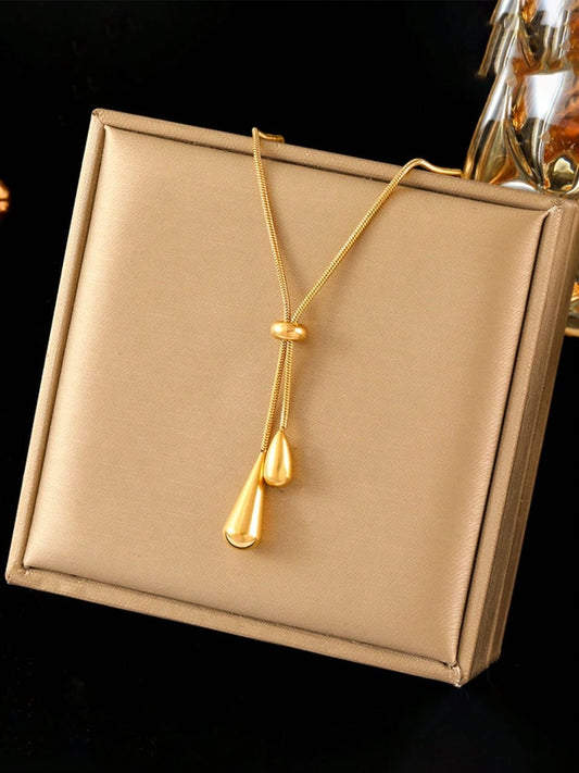 Elegant gold adjustable lariat necklace with teardrop pendants and sliding mechanism in luxury gift box - contemporary designer jewellery UK