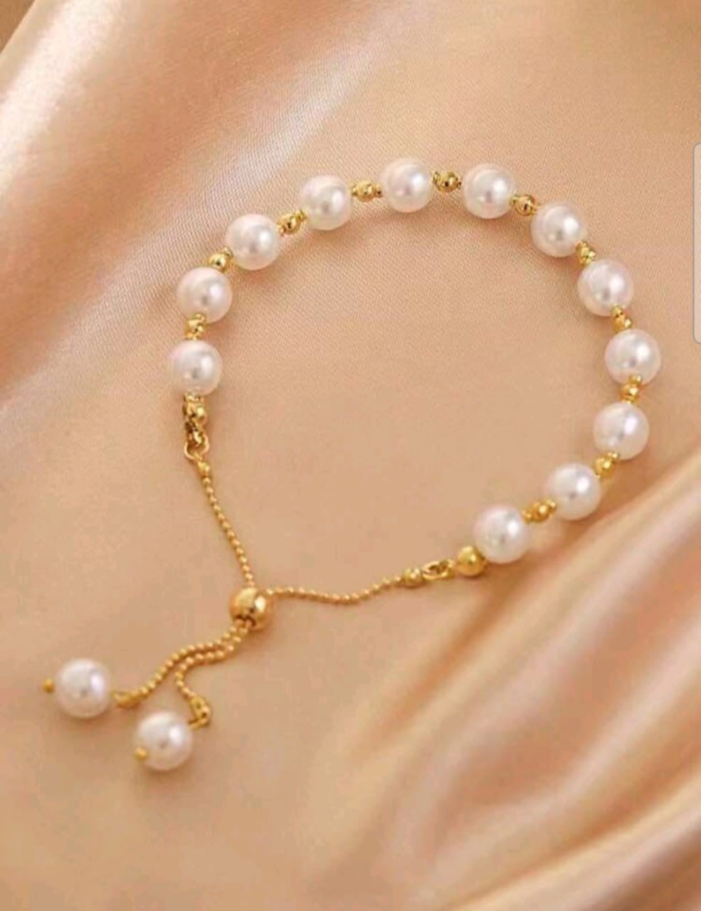 Elegant gold pearl adjustable slider bracelet with freshwater pearls and gold spacer beads featuring no-clasp design - luxury designer jewellery UK