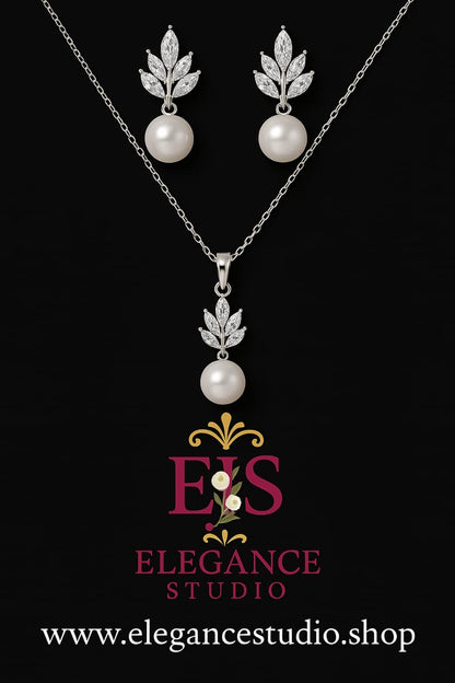 Silver crystal leaf and pearl necklace and earrings jewelry set with botanical design and elegant bridal styling on black background