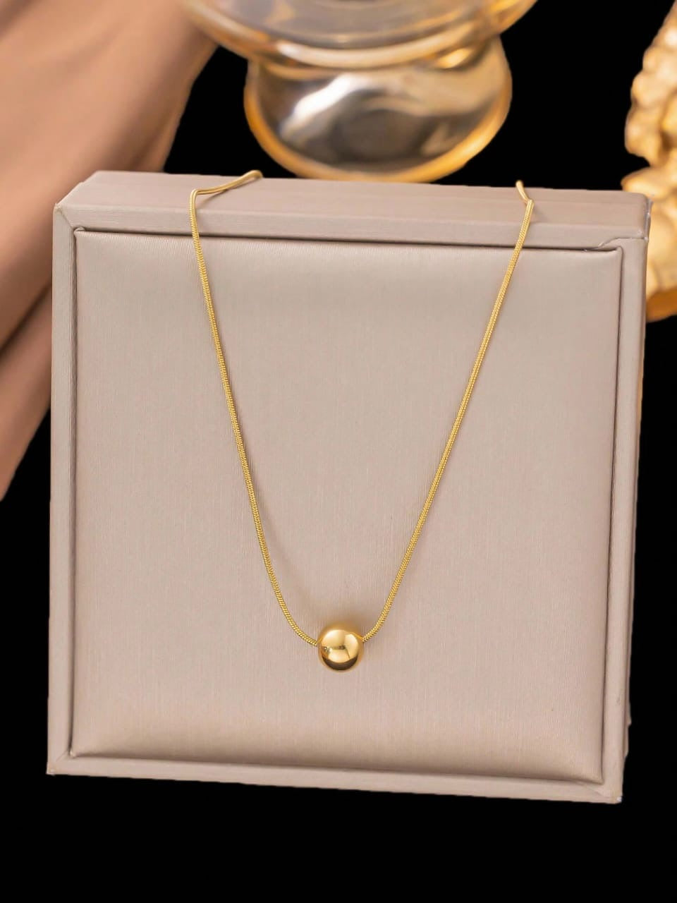 Minimalist gold ball pendant necklace on delicate snake chain- contemporary designer jewellery for UK customers