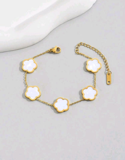 Elegant gold chain bracelet with five white mother of pearl clover motifs - luxury designer jewellery featuring natural iridescent stones for UK customers