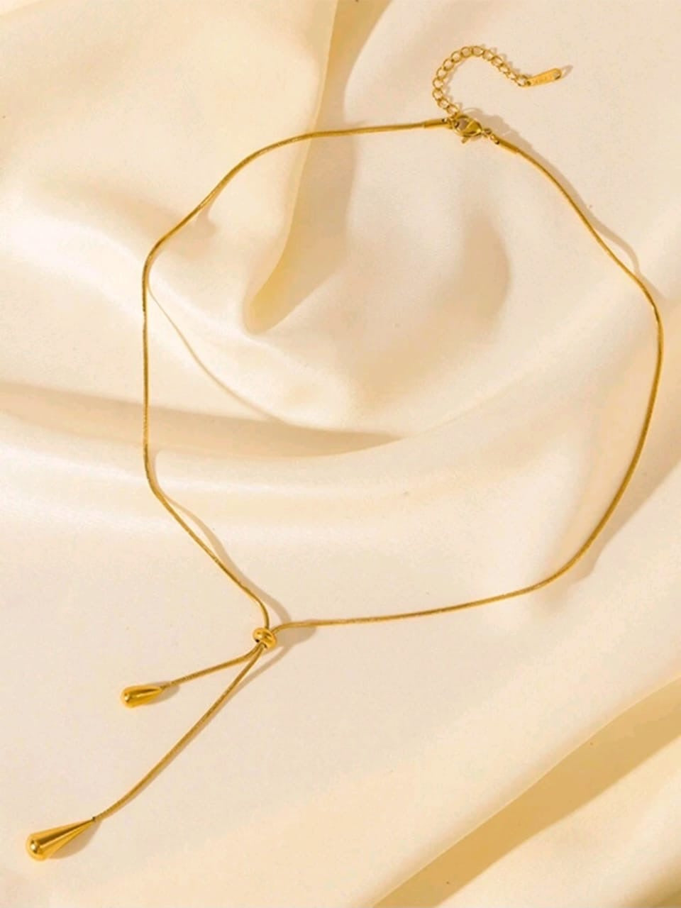 Elegant gold adjustable lariat necklace with teardrop pendants and sliding mechanism in luxury gift box - contemporary designer jewellery UK