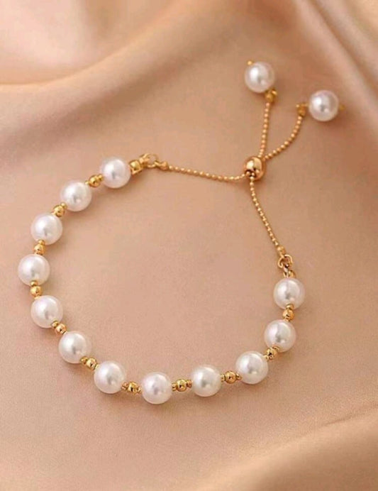 Elegant gold pearl adjustable slider bracelet with freshwater pearls and gold spacer beads featuring no-clasp design - luxury designer jewellery UK