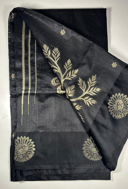 Black silk saree with gold woven floral motifs showing elegant traditional Indian design and luxurious silk fabric texture