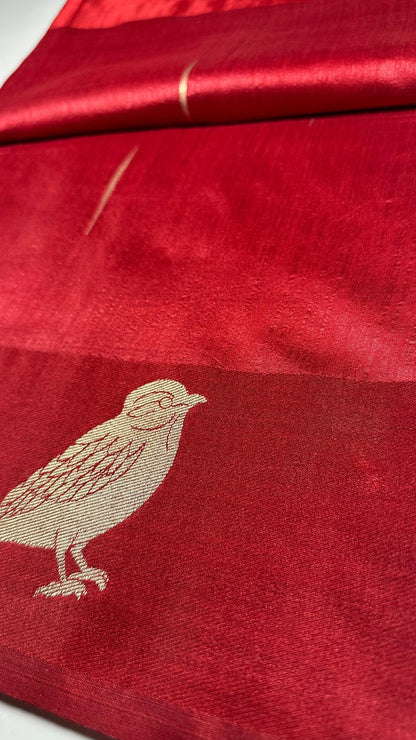  Red silk saree with woven bird and floral motifs showing traditional Indian wedding design and lustrous silk fabric with gold zari work