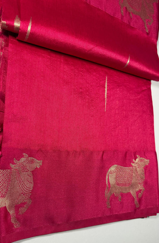 Magenta silk saree fabric texture with Gau Mata patterns and gold zari work showing spiritual and cultural significance