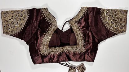 Back view of maroon silk blouse showing tie-up design with embroidered tassels and detailed traditional embroidery work