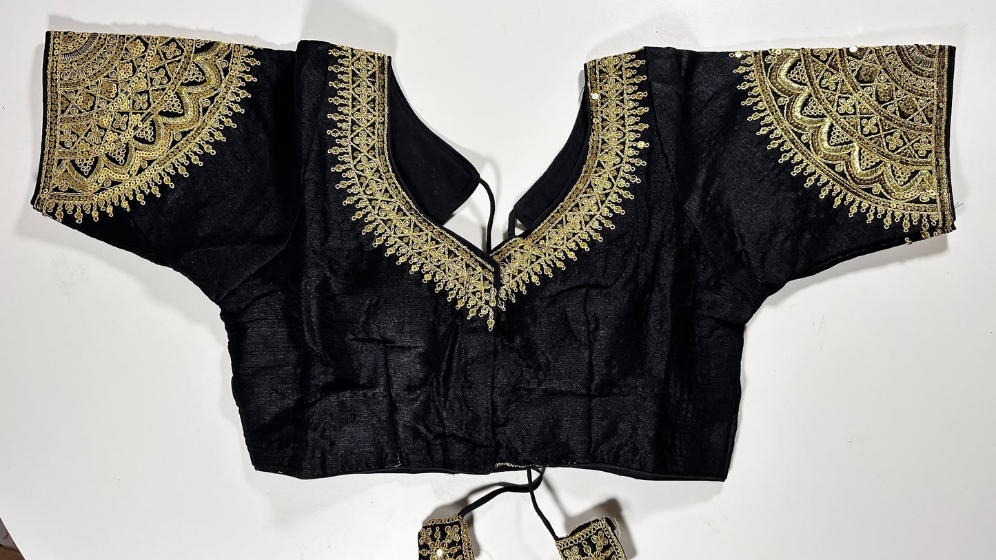 Black embroidered saree blouse with heavy zardozi work showing traditional Indian designer choli with intricate gold handwork