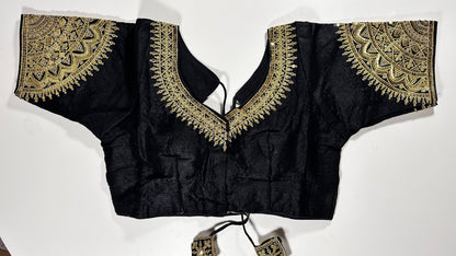 Black embroidered saree blouse with heavy zardozi work showing traditional Indian designer choli with intricate gold handwork