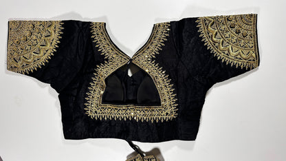 Back view of black silk blouse showing tie-up design with embroidered tassels and detailed traditional embroidery work