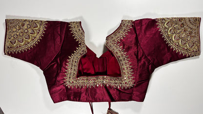 Traditional Indian luxury choli in rich wine burgundy silk with elaborate gold embroidery perfect for elegant occasions