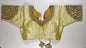 Luxury golden silk saree blouse with heavy zardozi embroidery featuring paisley motifs, deep V-neck design, and traditional Indian craftsmanship - front view