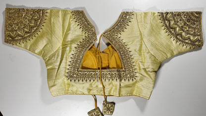 Golden embroidered saree blouse back view showing detailed threadwork, hook closure, and matching tassels - Indian wedding wear UK