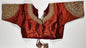 Rust red silk saree blouse with gold zardozi embroidery, featuring paisley motifs and traditional Indian threadwork - front view with decorative tassels