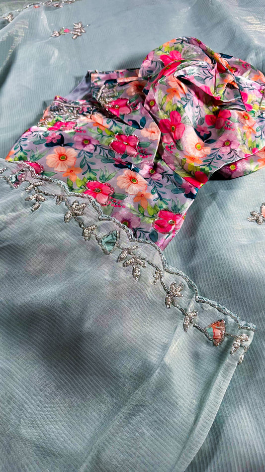 Mint blue silk saree with delicate floral embroidery and crystal work border detail showing traditional Indian craftsmanship