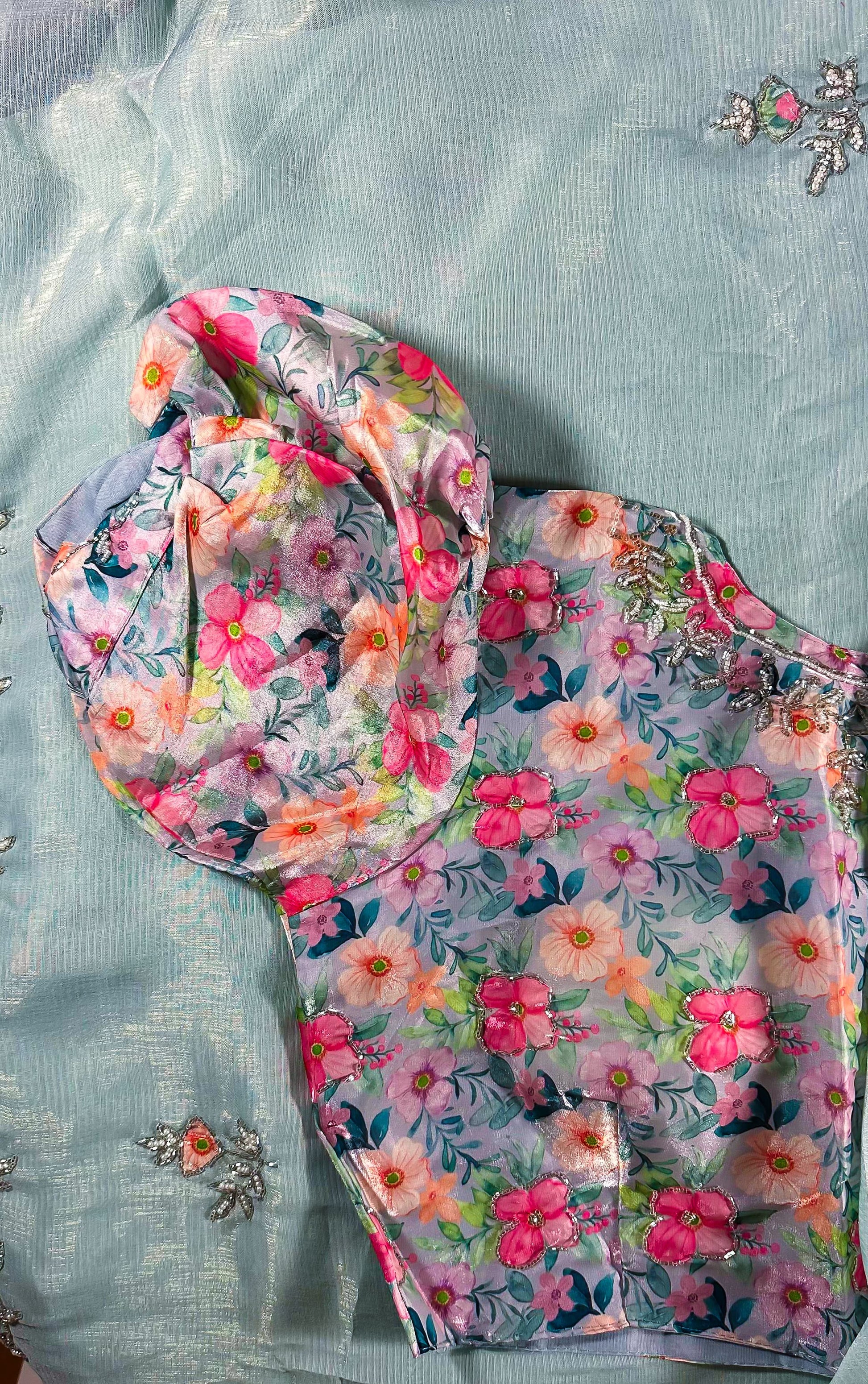 Vibrant floral print dupatta with pink and coral flowers coordinating with mint blue embroidered saree set