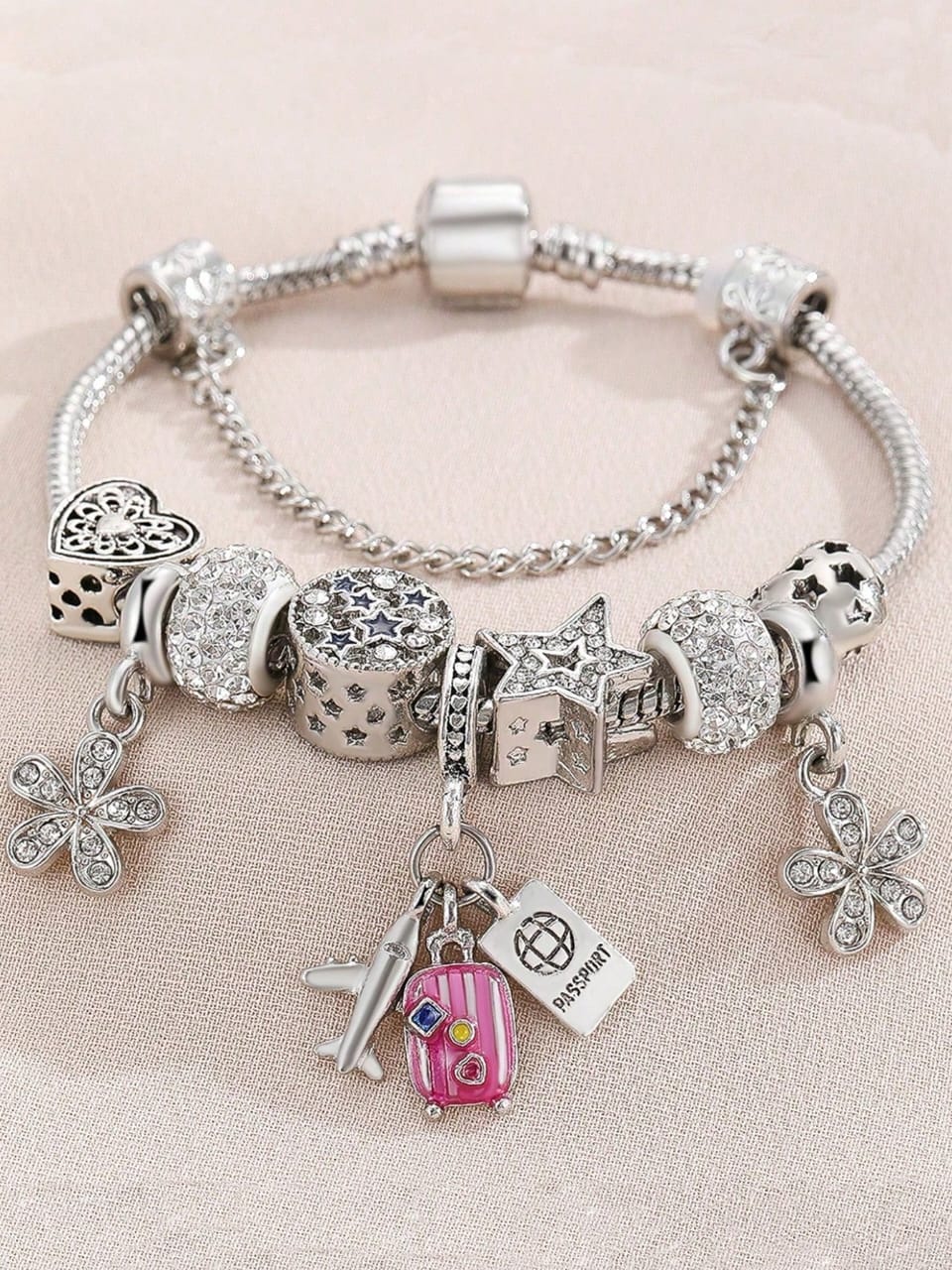 Silver travel theme charm bracelet with pink suitcase, airplane, passport and butterfly charms plus crystal beads - Pandora style jewellery for UK travel enthusiasts