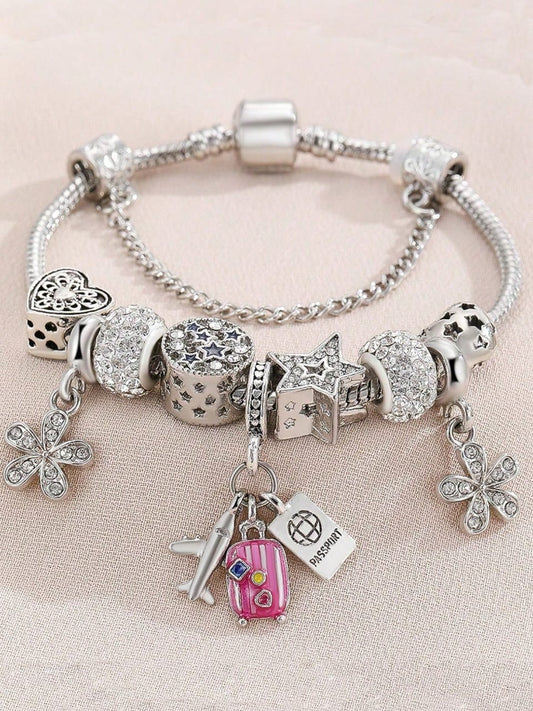 Silver travel theme charm bracelet with pink suitcase, airplane, passport and butterfly charms plus crystal beads - Pandora style jewellery for UK travel enthusiasts