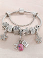 Silver travel theme charm bracelet with pink suitcase, airplane, passport and butterfly charms plus crystal beads - Pandora style jewellery for UK travel enthusiasts