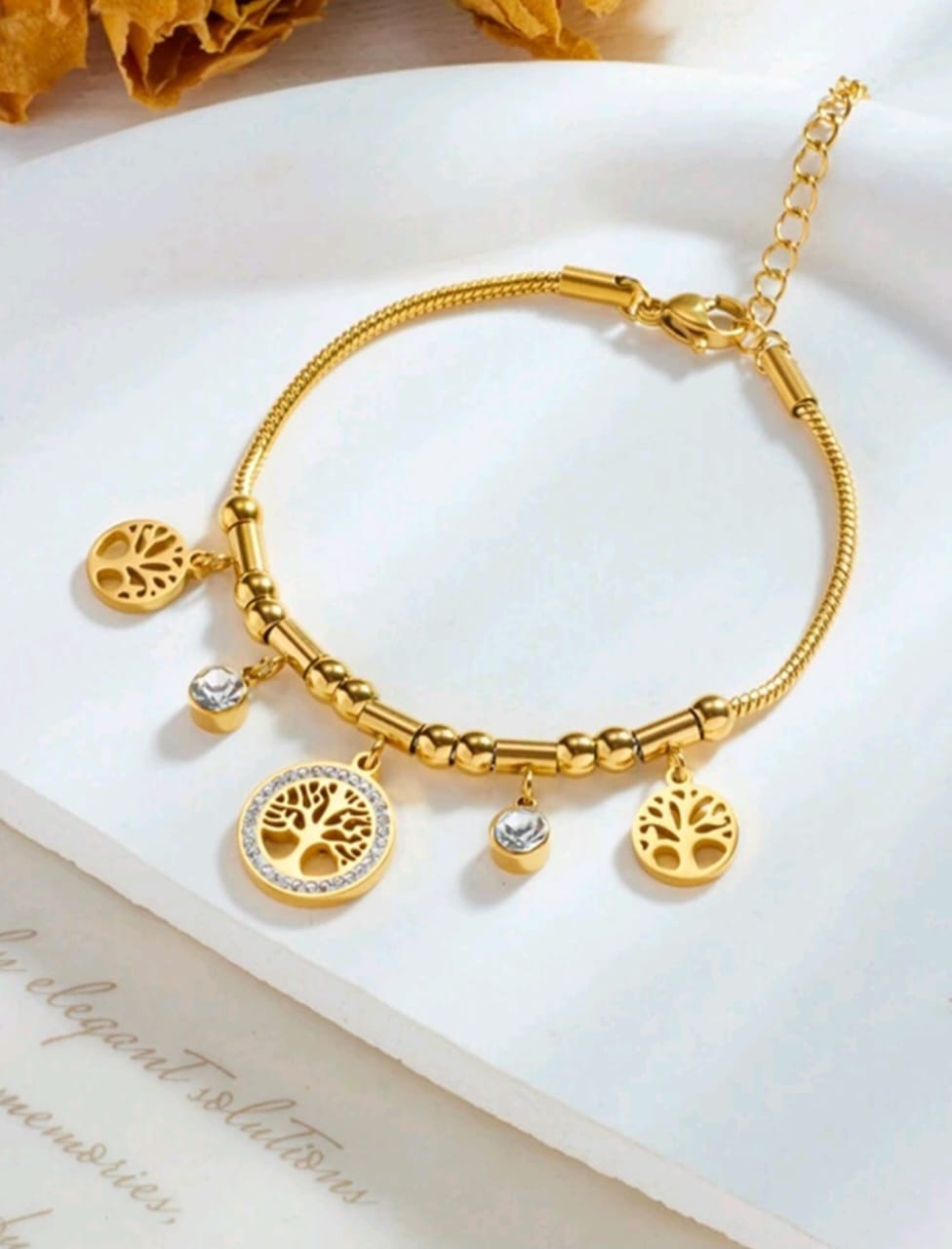 Gold Tree of Life charm bracelet with multiple symbolic tree pendants and crystal accents in elegant gift box - meaningful jewellery for UK customers