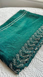 Luxurious emerald green silk saree with intricate silver hand embroidery featuring botanical leaf patterns and pearl accents - premium Indian designer saree UK