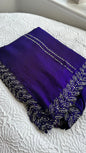 Elegant royal blue barberry saree with intricate silver gota work embroidery featuring detailed leaf patterns along the border, beautifully displayed on white textured background