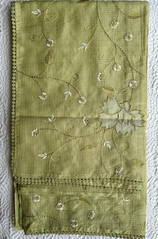 Beautiful olive green kota cotton saree with delicate lotus applique work and floral embroidery scattered across the fabric, featuring decorative scalloped border, displayed on white textured background