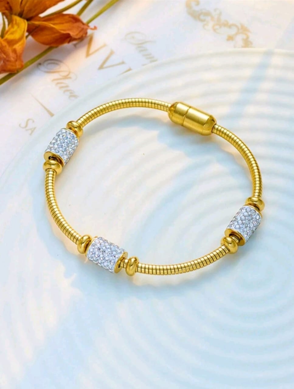 Gold tone crystal charm bracelet on marble surface - Indian ethnic jewellery UK online