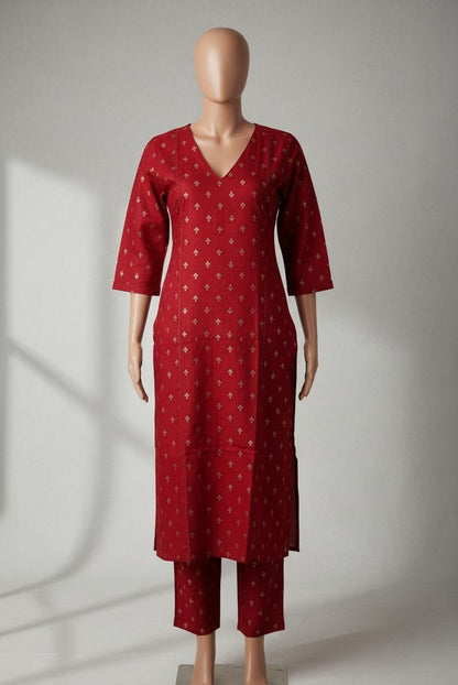 Red patterned dress on a mannequin against a neutral background