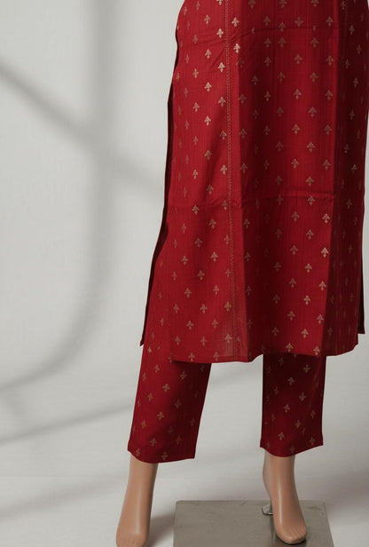 Red patterned outfit on a mannequin against a plain background