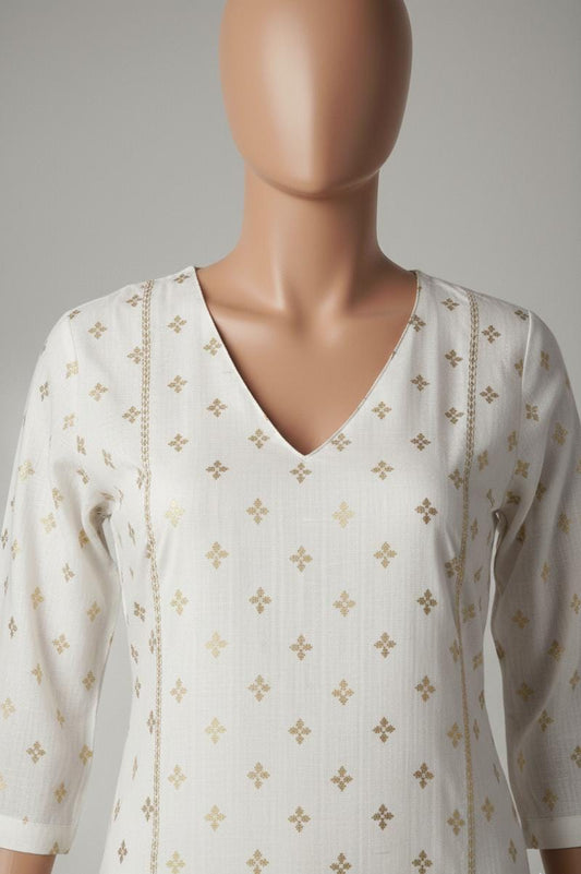 Mannequin wearing a white blouse with gold patterns on a plain background