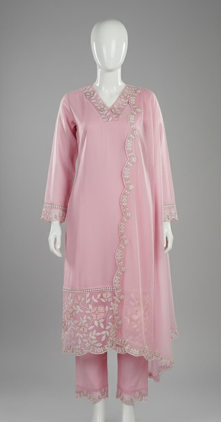 Pastel pink embroidered suit set with floral lace border, V-neck kurta, matching pants, and dupatta — elegant festive outfit for women.
