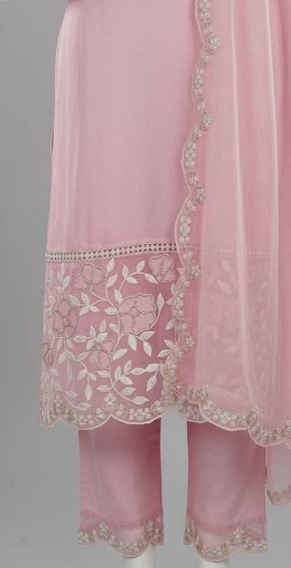 Pastel pink embroidered suit set with floral lace border, V-neck kurta, matching pants, and dupatta — elegant festive outfit for women.
