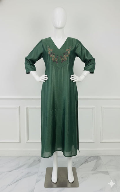 Emerald green silk embroidered dress with hand beadwork, V-neck design, and festive shimmer — elegant Christmas outfit for women.