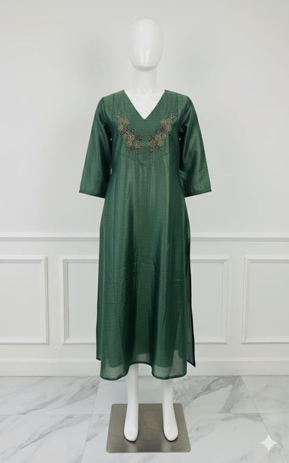 Emerald green silk embroidered dress with hand beadwork, V-neck design, and festive shimmer — elegant Christmas outfit for women.