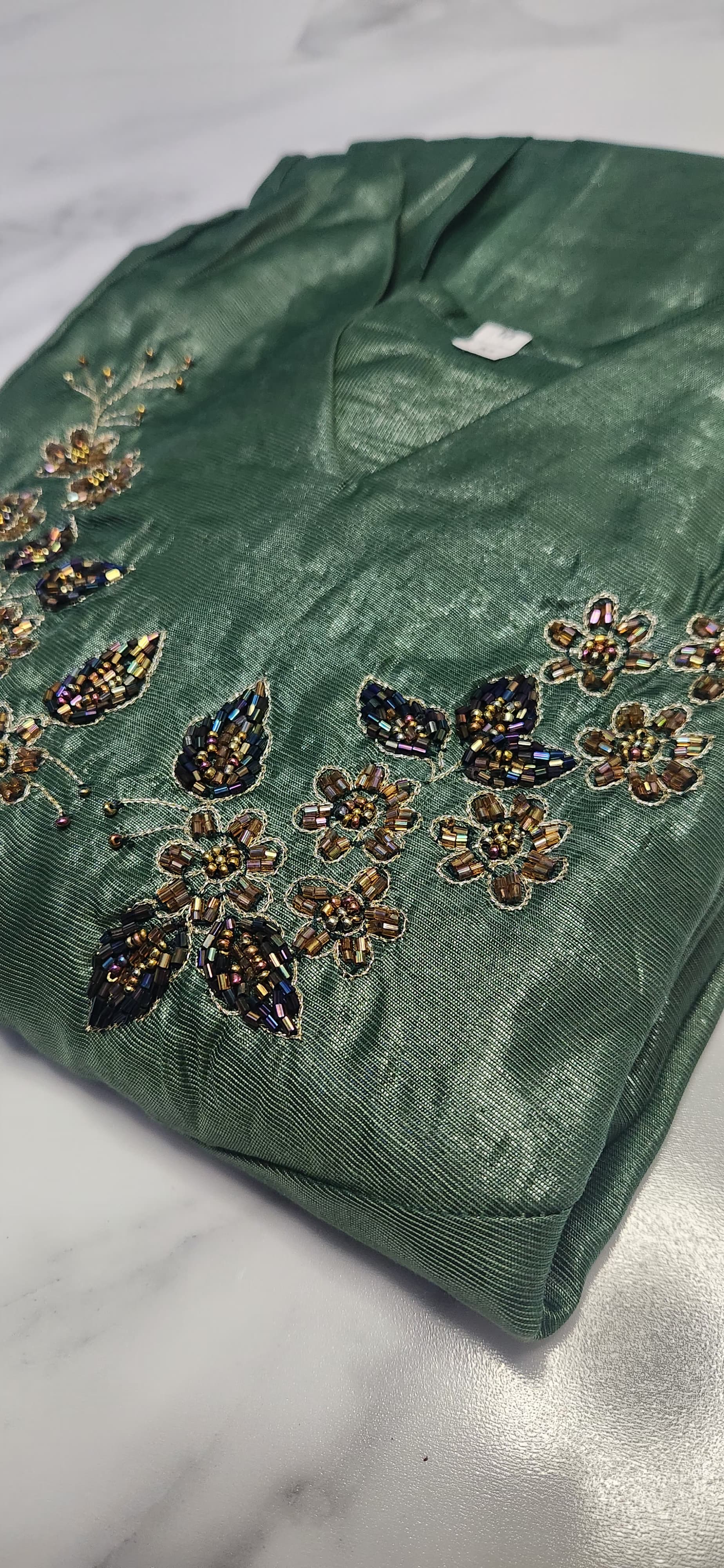 Emerald green silk embroidered dress with hand beadwork, V-neck design, and festive shimmer — elegant Christmas outfit for women.