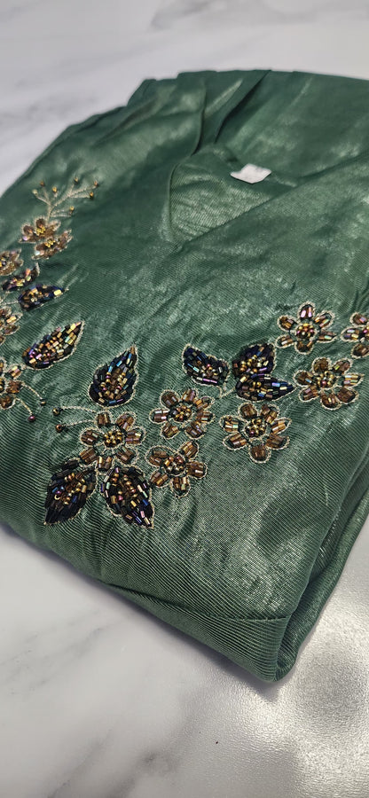 Emerald green silk embroidered dress with hand beadwork, V-neck design, and festive shimmer — elegant Christmas outfit for women.