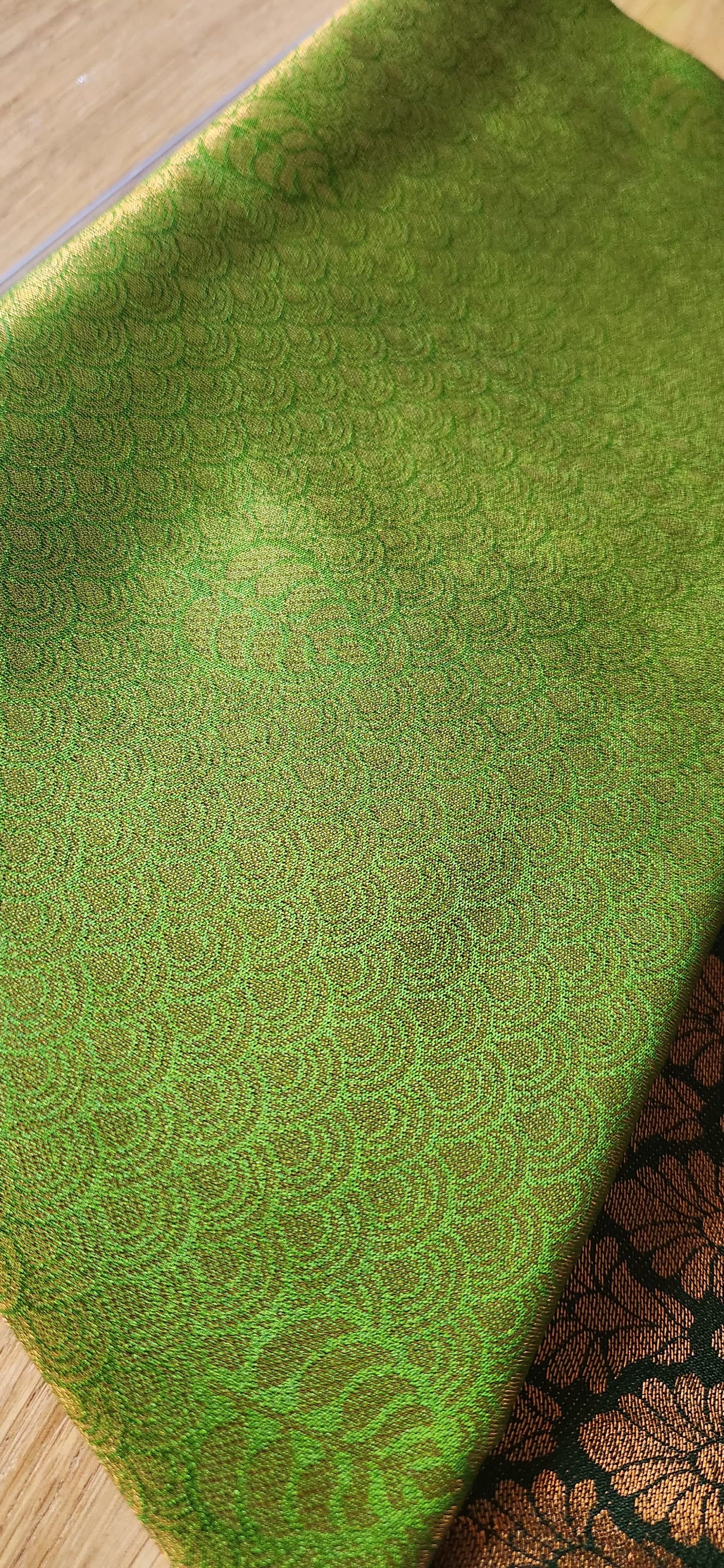 Kubera Silk Signature Traditional Border Saree with woven silk body and intricate traditional border, neatly styled on a tabletop with minimal décor.